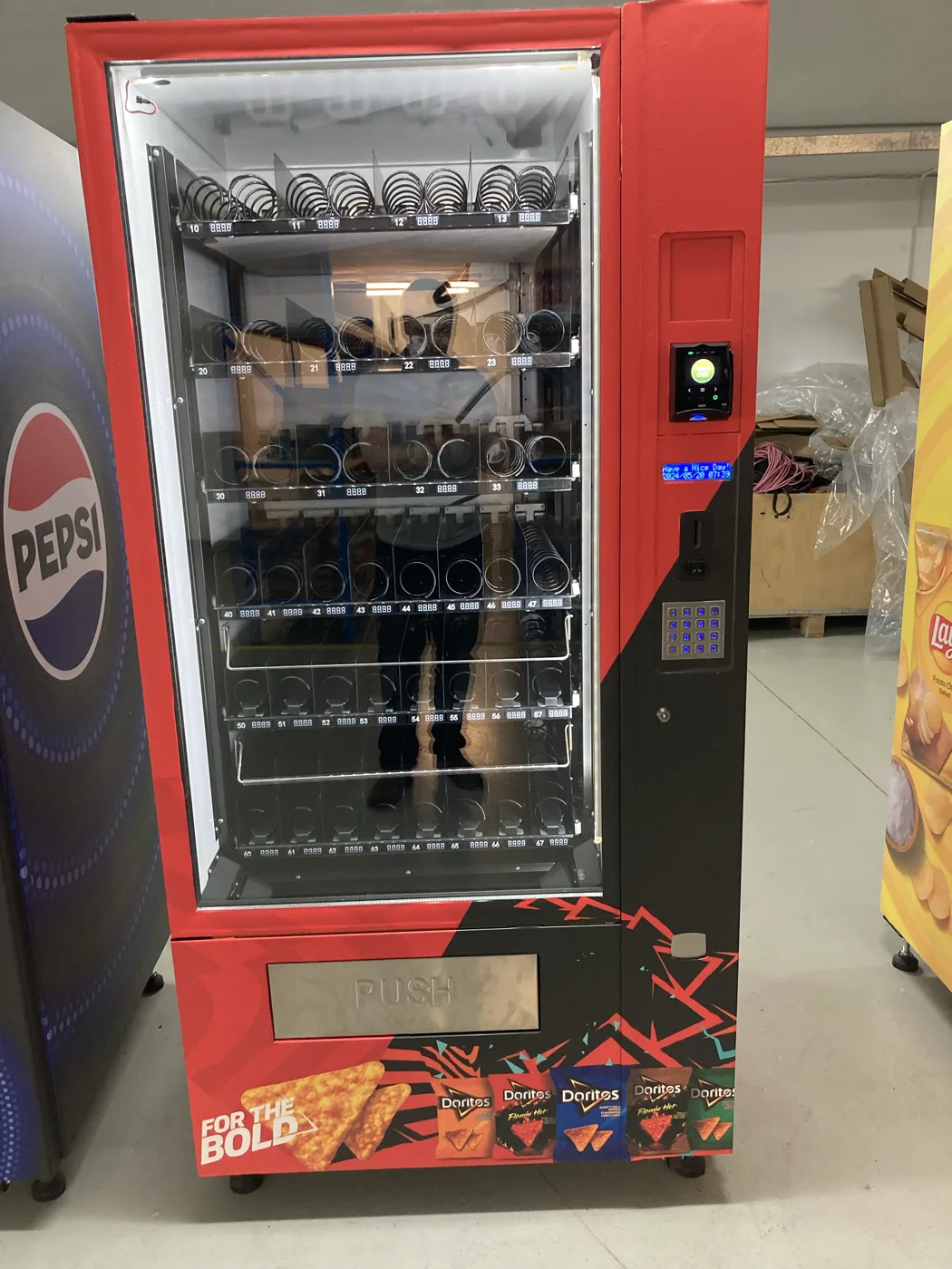 Doritos, Pepsi and Lay's wrapped machines side by side in the workshop