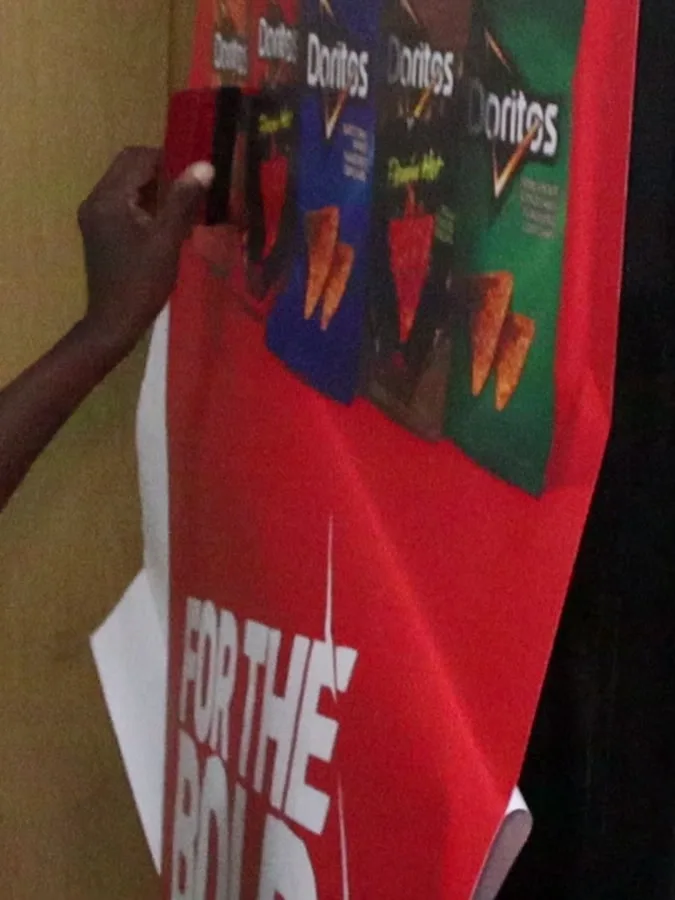 Doritos vinyl being applied as the backing paper peels away