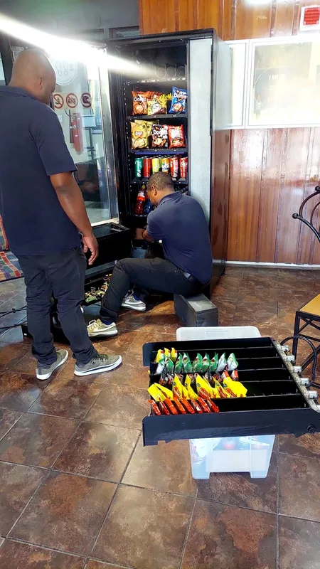 The team restocking a snack machine