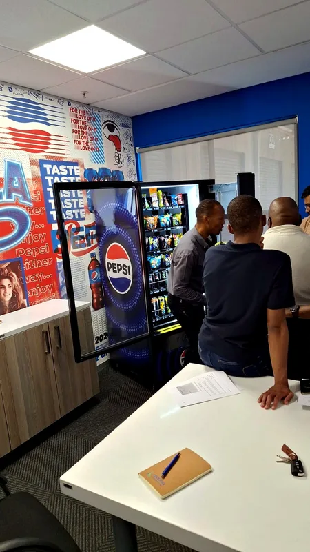 Vending Solutions team reviewing a drinks machine placement in an office