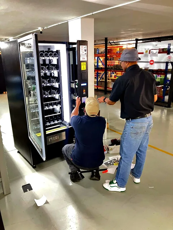 Two technicians servicing a combo machine