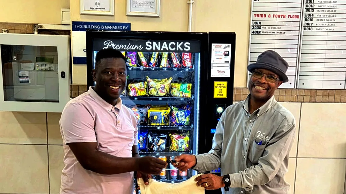 New vending machine owner receiving a stocked snack machine in an office lobby