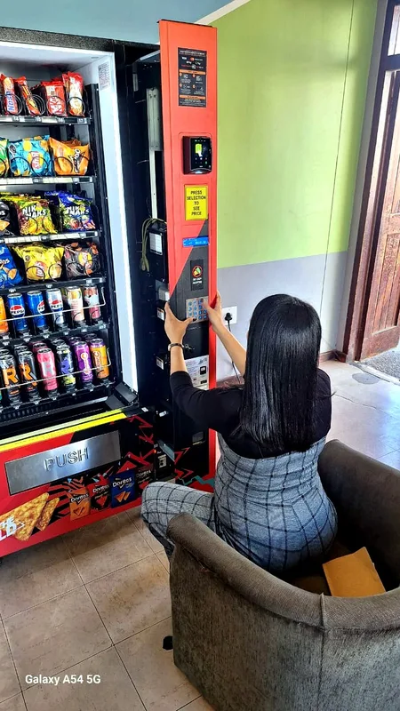 An owner filling her own machine, her own way