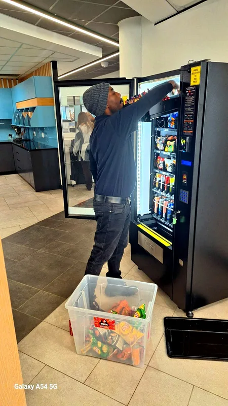 Restocking a snack machine at an office site