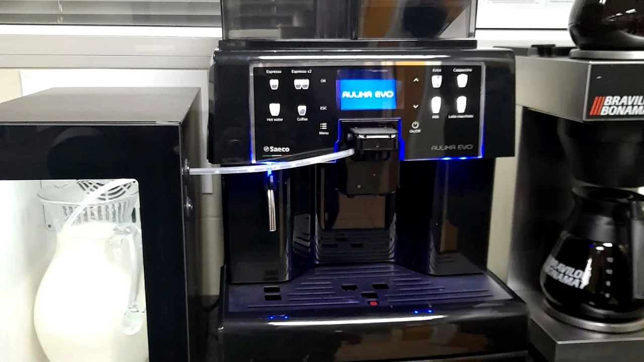 Saeco Aulika Evo bean-to-cup machine and milk fridge on a client office kitchen counter