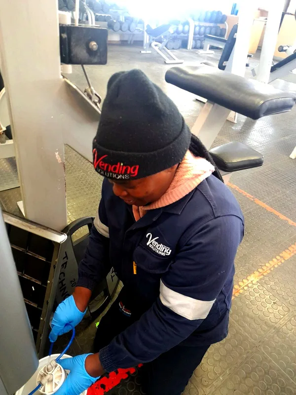 Servicing a machine on a gym floor